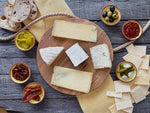 Load image into Gallery viewer, 5 cheeses on a circular wooden board. Six clay dishes, two containing pickles, 2 of chutney and one each of olives and sundried tomatoes. Four slices of sourdough bread and an array of crackers.
